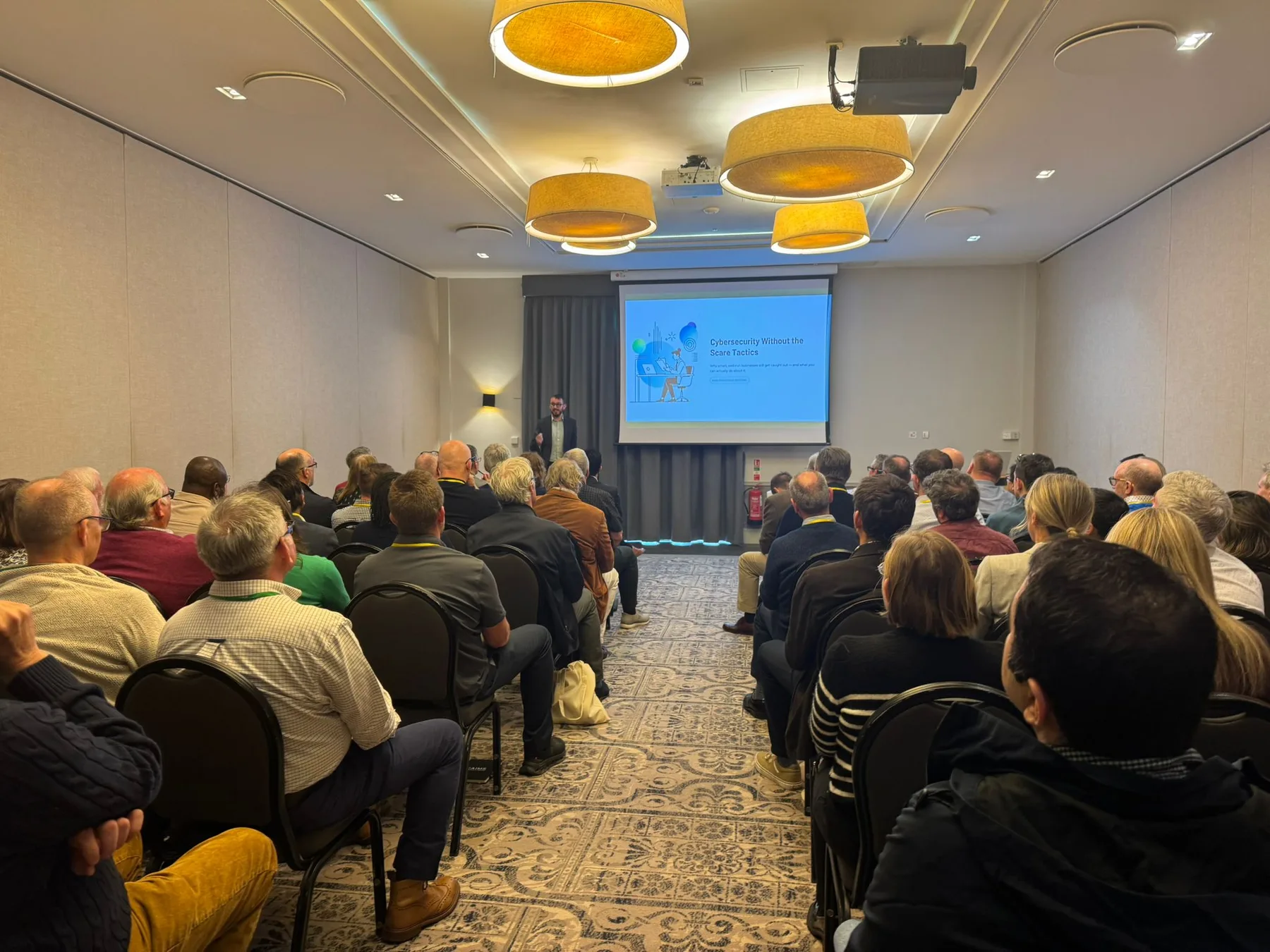 Tom presenting Cyber Security Without the Scare Tactics to a conference audience