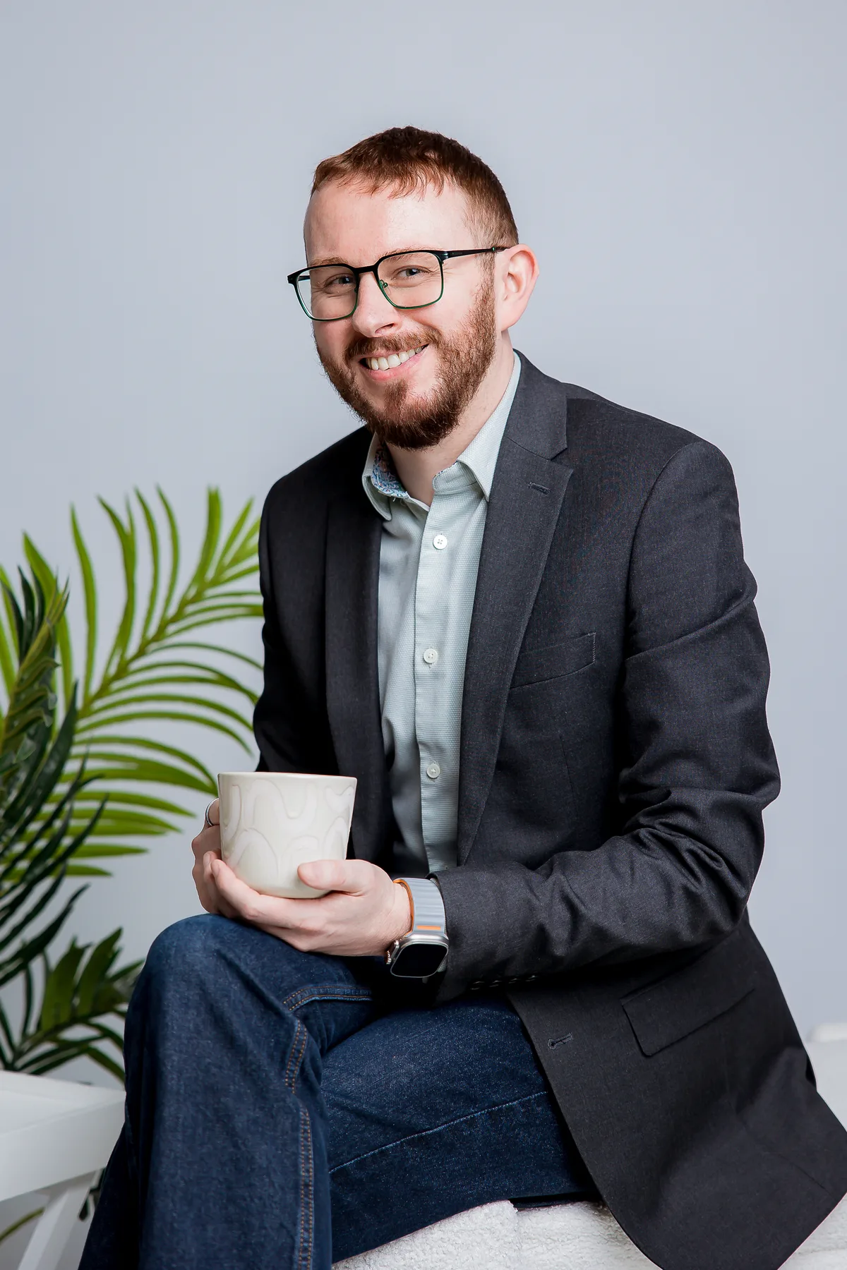 Tom Reveley seated with a coffee